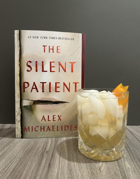 The Silent Patient and Silent Seven cocktail in front of grey wall