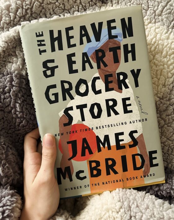 The Heaven and Earth Grocery Store held up on grey blanket.